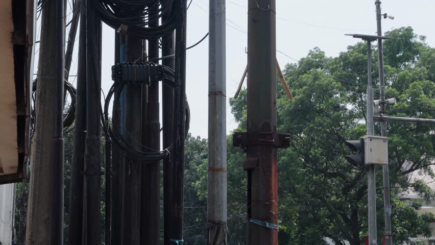 chaotic messy untidy dangerous electric high voltage fiber optic telephone cable power pole fire hazard tangled