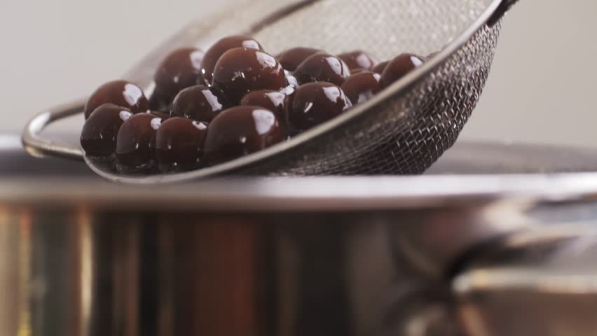 Cooking, boiling brown sugar flavor tapioca pearl balls, chinese food, ingredient of bubble tea, preparing food and drink, close up, recipe cookbook steps design concept.