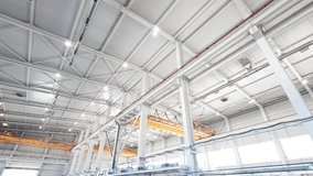 Crane runway girder and metal supporting structures of industrial workshop. Bridge cranes inside hangar. Overhead traveling gantry crane beams on the pillars and truss ceilings of industrial building - Powered by Shutterstock - Get 15% off with code: PIKWIZARD15