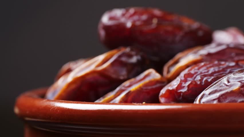 Fresh dates fruits close up on kitchen, close up in supermarket. Eating dried fruits. Vegan, vegetarian food. 