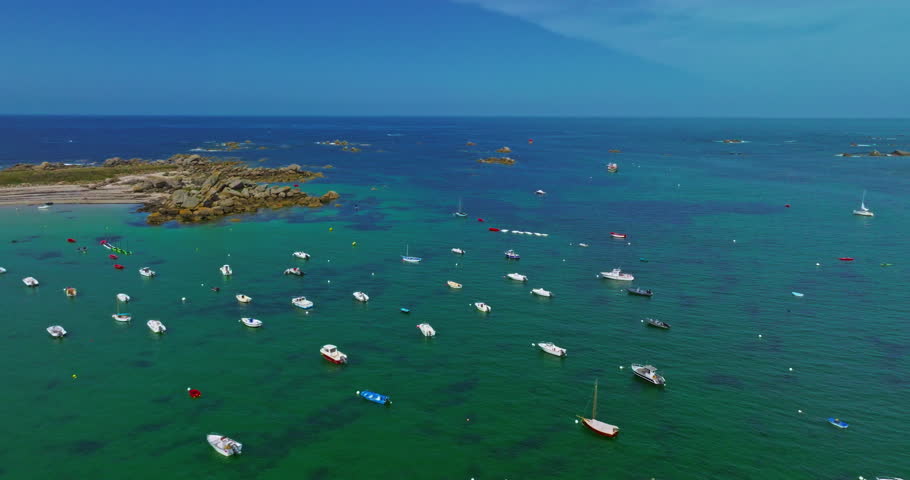 Aerial view of fishing boats anchored near the shore with beautiful water in the background. France