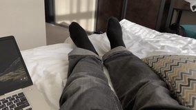 A freelancer enjoys the comfort of working from home, resting in bed with a laptop computer nearby - Powered by Shutterstock - Get 15% off with code: PIKWIZARD15