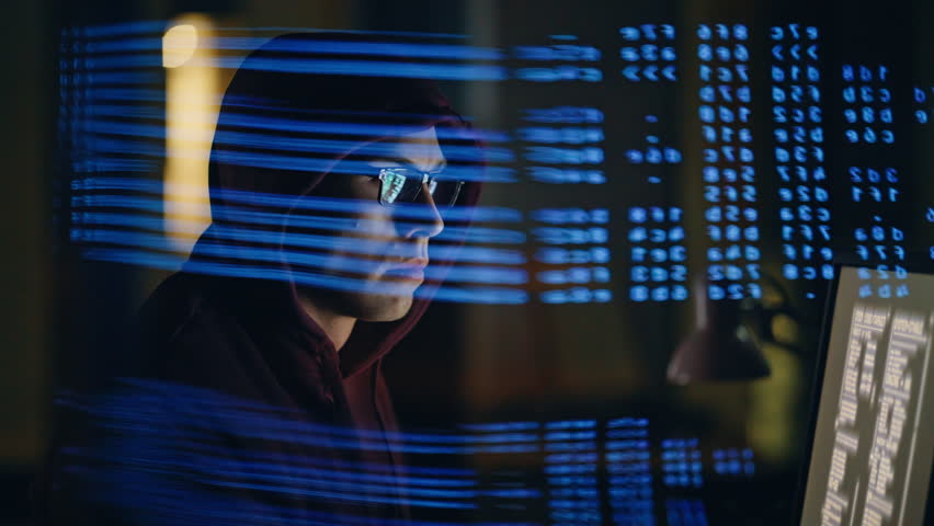 Code projection hacker breaking system at night room closeup. Cyber attacker programmer manipulating secure databases under shadowy lighting. Fraudster exploiting algorithms observing screen remotely