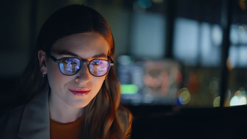 Woman stockbroker working late at night trading on computer closeup. Businesswoman in eyeglasses analyzing financial data on laptop screen reviewing charts focusing on graphs future strategy planning 
