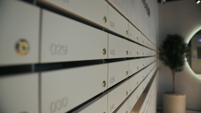 Row of numbered apartment mailboxes with keyholes