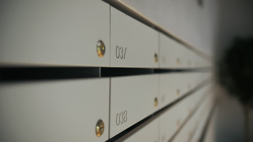 Row of numbered apartment mailboxes with keyholes