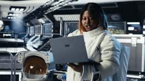 Cosmonaut leaving starship after landing on planet, waving hand to colleague. Astronaut stepping out of space station for scheduled operations to study cosmic origins, camera B - Powered by Shutterstock - Get 15% off with code: PIKWIZARD15