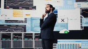 Businessman thinking about a new solution to increase funding while he evaluates infographics and financial reports with digital technology. Planning long term success and growth. Camera B. - Powered by Shutterstock - Get 15% off with code: PIKWIZARD15