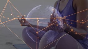 Woman meditating on yoga mat by ocean initiating data network converging into mesh globe with code. Spirituality, serenity, connectivity, technology, mindfulness, abstract, wellness - Powered by Shutterstock - Get 15% off with code: PIKWIZARD15
