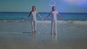 woman and man walking onto wet sand, shifting into tree pose while digital circles swirling. Balance, serenity, mindfulness, spirituality, harmony, wellness, meditation - Powered by Shutterstock - Get 15% off with code: PIKWIZARD15