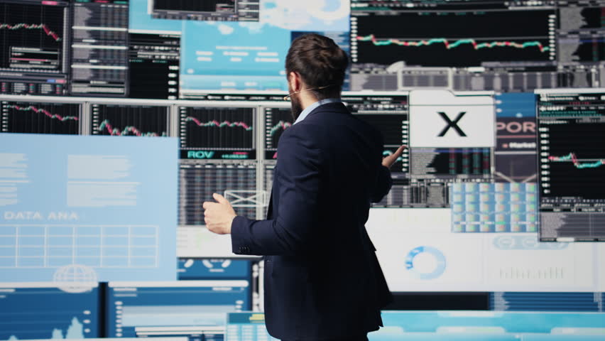 Professional businessman delivers inspiring business pitch on stage, using a hands free microphone. Visionary CEO and motivational speaker addresses attendees with charts and data. Camera B.