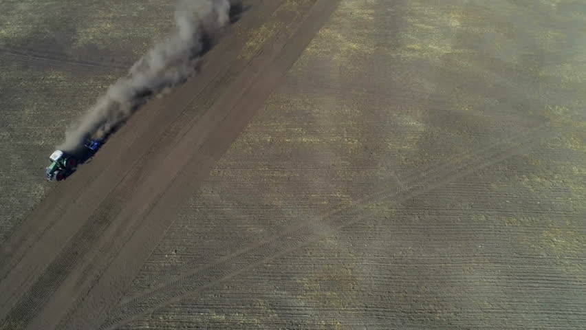 Drone view starting truck driving along track trailing smoke as telemetry bars showing performance. Offroad, machinery, landscape, rural, data, technology, performance