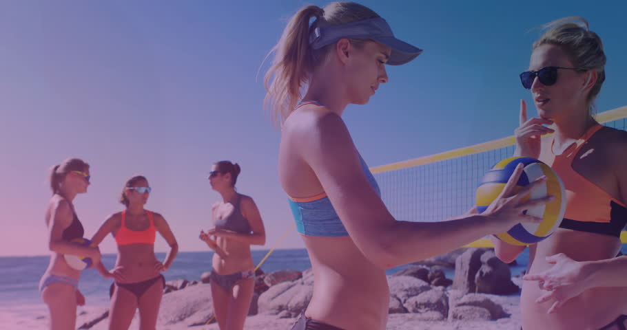 Beach volleyball player in blue receiving ball near net and listening to signal for serving plan. Athletic, team, summer, outdoor, vibrant, active, sport