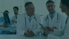 Doctor examining X-ray while team tapping tablet and spawning floating icons for record review. Medical, collaboration, innovation, technology, healthcare, analysis, digital - Powered by Shutterstock - Get 15% off with code: PIKWIZARD15