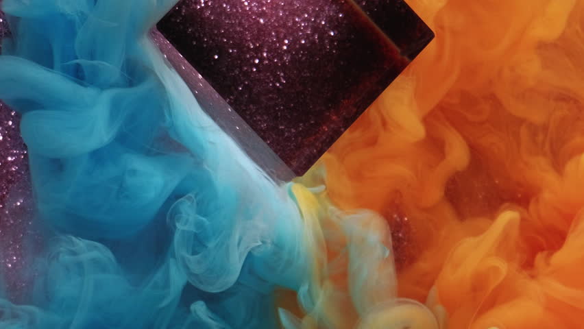 Multicolored smoke. Haze mix. Blue orange blur stream fume paint spreads on glitter abstract background. Smooth ink exploding cloud in water.