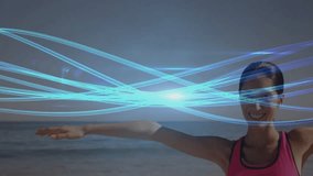Woman lifting arms overhead activating light trails performing side fitness stretch on sandy beach. Health, wellness, exercise, vitality, movement, serenity, outdoor - Powered by Shutterstock - Get 15% off with code: PIKWIZARD15