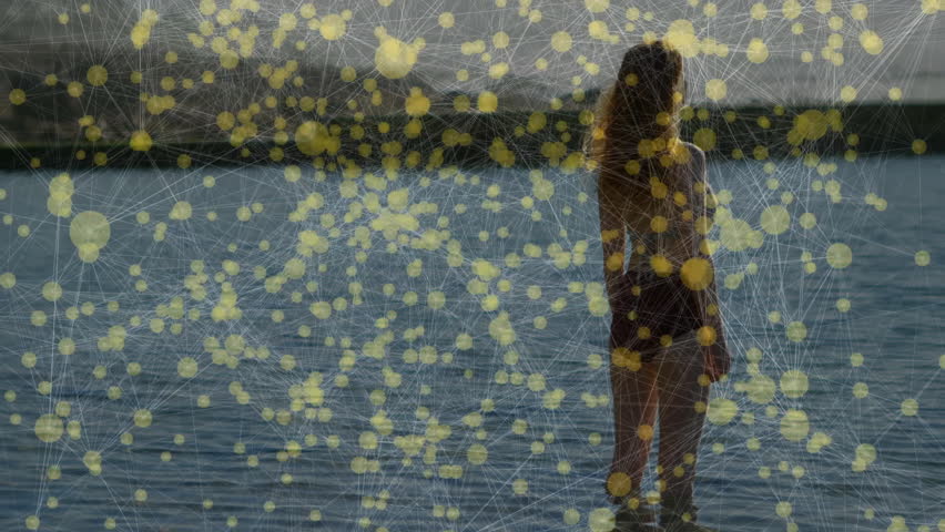 Solitary woman wading in shallow water while particle network fading and revealing her in tech demo. Digital, serenity, exploration, futuristic, minimalism, nature, calm