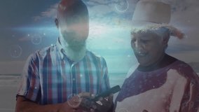 Tapping smartphone screen, mature couple capturing beach selfie with animated technology overlays. Romantic, outdoor, vibrant, leisure, digital, connection, lifestyle - Powered by Shutterstock - Get 15% off with code: PIKWIZARD15