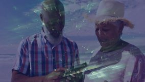 Senior couple standing shoreline exploring smartphone tech swiping framing selfie and capturing pic. Senior, companionship, technology, leisure, vacation, harmony, lifestyle - Powered by Shutterstock - Get 15% off with code: PIKWIZARD15