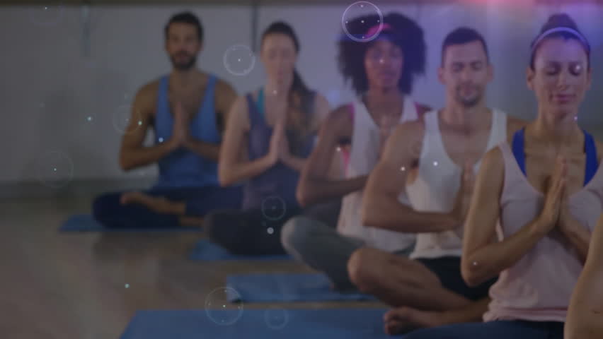 Yoga participants settling into prayer pose triggers digital overlay enhancing meditation in health. Meditation, mindfulness, harmony, serenity, technology, spirituality, wellness