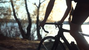cyclist riding on road bike. cyclist holding handlebars of a racing bike during outdoor cycling session. The cyclist is enjoying nature and cycling along a scenic trail. Cycling bike active lifestyle - Powered by Shutterstock - Get 15% off with code: PIKWIZARD15