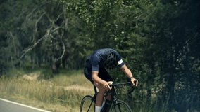 cyclist rides road bike through a forest, enjoying cycling workout. The cyclist maintains speed and form during intense cycling. Cycling in nature supports fitness and endurance goals. Cardio fitness - Powered by Shutterstock - Get 15% off with code: PIKWIZARD15