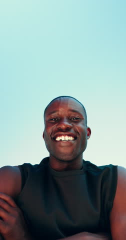 Fitness, flexing and face of black man by blue sky for muscle workout, practice or training. Sports, happy and portrait of African athlete with biceps outdoor for exercise from below by mockup space.