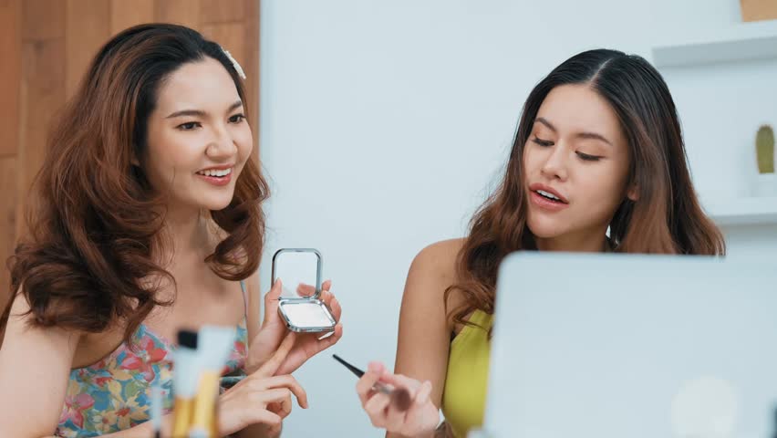 Two influencer partner shoot live streaming vlog video review makeup social media or blog. Happy young girl with vivancy cosmetics studio lighting for marketing recording session broadcasting online.