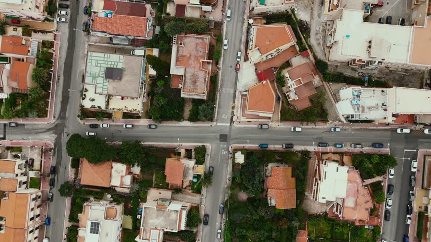 Top-down aerial shot of intersecting streets in Porticello near Palermo, showing Mediterranean-style homes, parked cars, and urban patterns in a quiet residential district