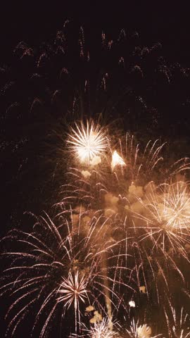Spectacular fireworks burst in a kaleidoscope of colors against the darkened sky, captivating viewers during the local celebration. The explosions create a lively atmosphere filled with excitement.