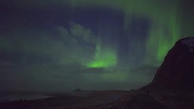 Gorgeous 4K time-lapse of vibrant Northern Lights dancing over Arctic mountains, showcasing auroral movement and celestial interaction. - Powered by Shutterstock - Get 15% off with code: PIKWIZARD15