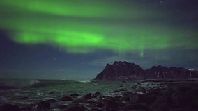 Stunning display of the Northern Lights as they illuminate a rocky coastline and rugged mountain landscape in Norway’s scenic Lofoten Islands under a starry Arctic sky. - Powered by Shutterstock - Get 15% off with code: PIKWIZARD15