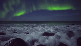 Captivating view of Aurora Borealis over rocky beach and ocean. Solar particles collide with atmosphere to create magical polar night sky colors. - Powered by Shutterstock - Get 15% off with code: PIKWIZARD15