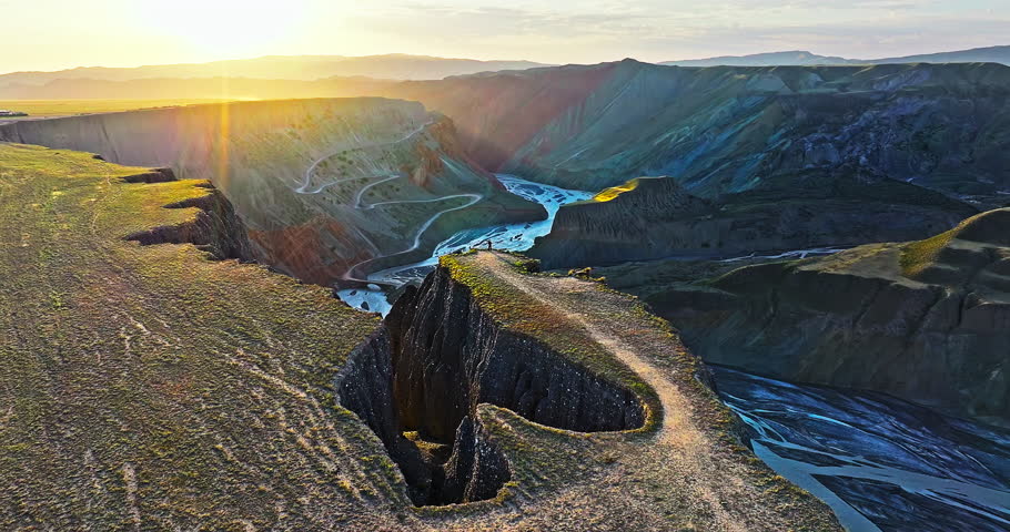 Aerial shot of the spectacular Anjihai Grand Canyon with a winding river natural landscape at sunrise in Xinjiang, China.