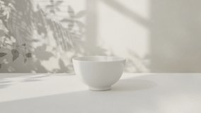 Minimalist white ceramic bowl on table with sunlight and leaf shadows - Powered by Shutterstock - Get 15% off with code: PIKWIZARD15