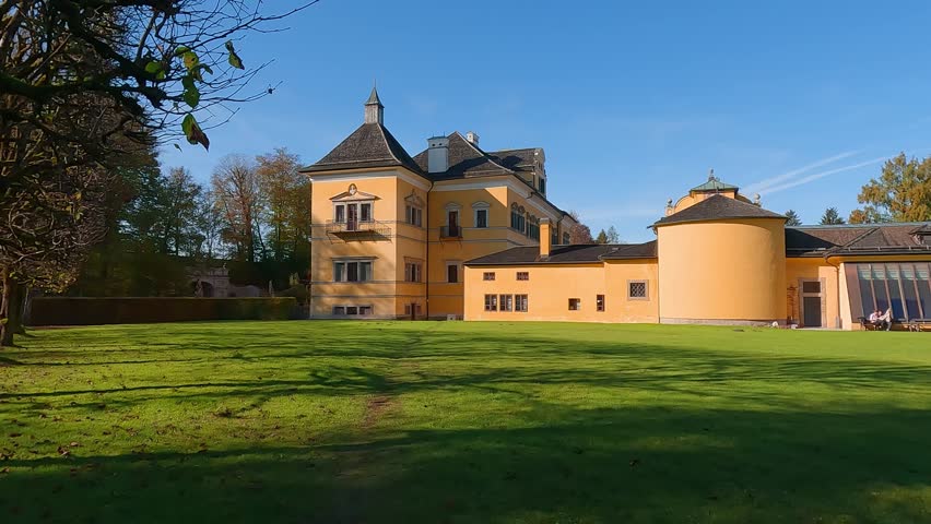 Attractive autumn view of Hellbrunn castle, Austria, Europe. Amazing morning cityscape of Morzg, district of Salzburg city, Austria, Europe. 4K video (Ultra High Definition).