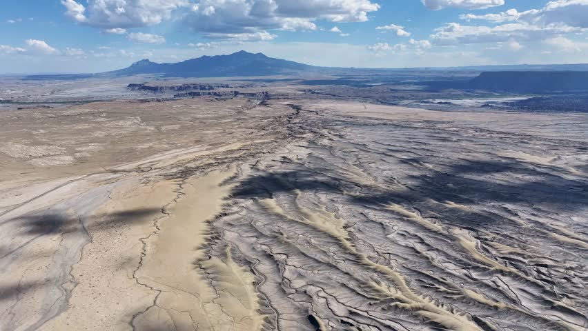 Aerial view of beautiful desert landscape with rugged mountains and serene sky, Hanksville, Utah, USA.