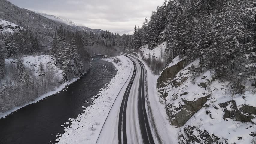 Cars Drive on Snowy Sea to Sky Highway in British Columbia
