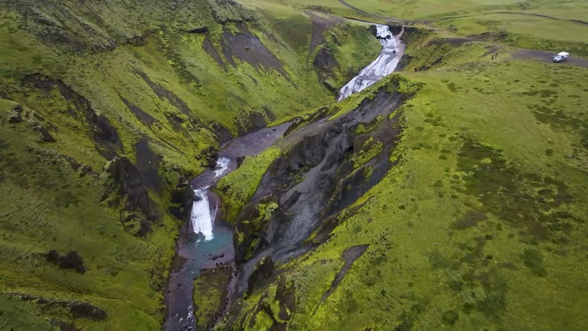 Aerial view of majestic waterfall cascading into a scenic canyon within a beautiful valley, Skaftarhreppur, Southern region, Iceland.