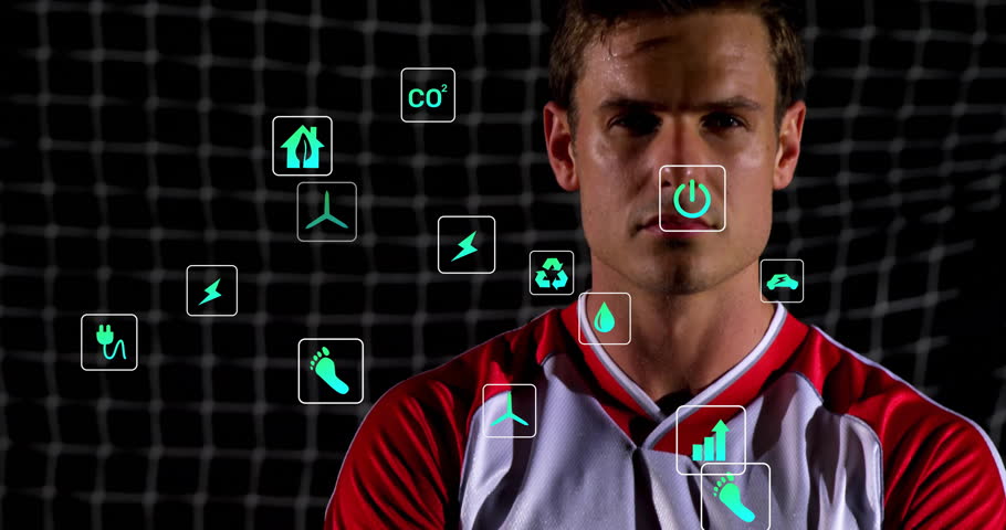 Soccer player standing while camera ascending in stadium showing drifting energy or recycling icons. Athlete, sportswear, environmental, sustainability, performance, stadium, energetic