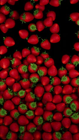 Falling juicy fresh red strawberries. 3D transition. Juicy summer background. 4K vertical
