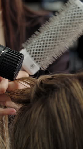 Round brush curling hair in salon