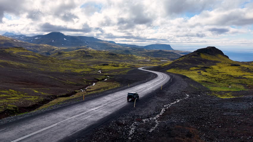 Car Through Iceland Landscape mountains Epic Scenic Road Trip Scene.