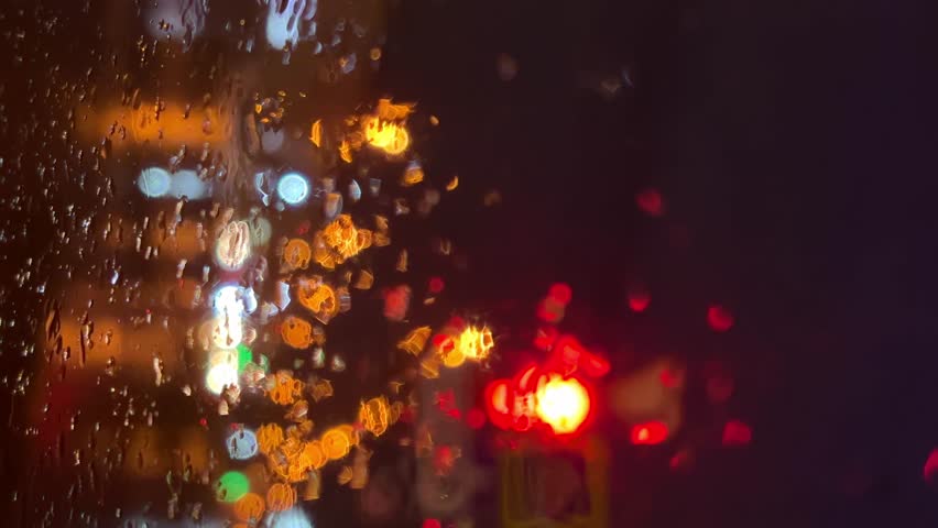 Raindrops on glass. Rain. Many cars. Vertical video. High-quality shooting in 4k format