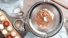 Baking delicious caramel pecan brownies. In a mixing bowl with a flour sifter adding flour and cocoa powder. Freshly baked gooey chocolate brownies with sweet caramel and nutty pecans. - Powered by Shutterstock - Get 15% off with code: PIKWIZARD15