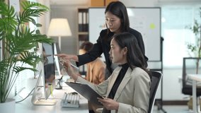 Project manager is helping an employee understand the data in a spreadsheet - Powered by Shutterstock - Get 15% off with code: PIKWIZARD15