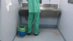 Surgeon scrubbing hands before surgery in OR - Powered by Shutterstock - Get 15% off with code: PIKWIZARD15