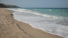 Waves rolling on sandy beach