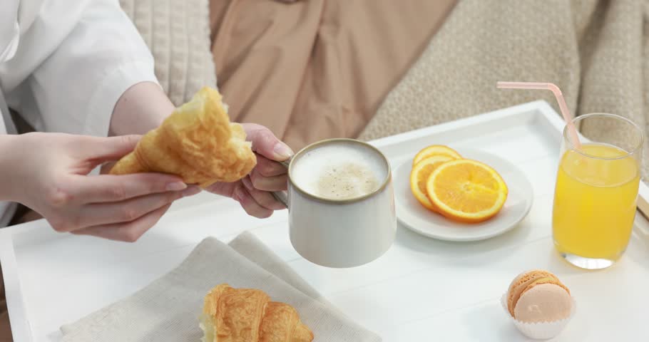 Woman having delicious breakfast in bed, closeup