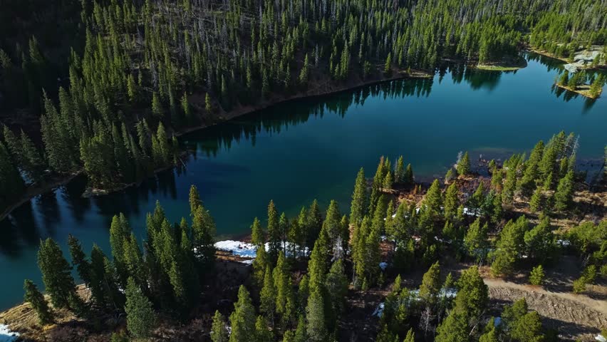 Sweeping drone establishing of high alpine valley surrounded by pines and rocky terrain, medium forest backdrop of Frisco Gulch Colorado USA